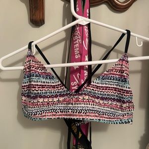 This is a pink printed bikini top by the brand SO in a size small.